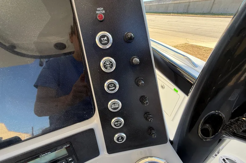 Slide: The Image of 2024 Robalo R230 Center Console dashboard with control buttons and high water alert. - 32