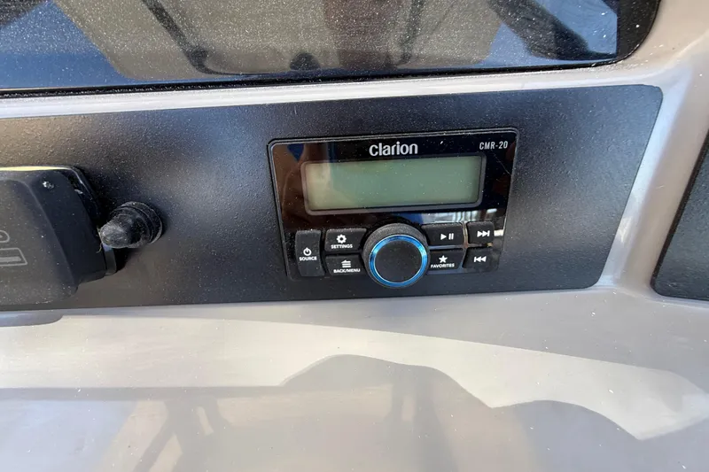 Slide: The Image of Clarion CMR-20 audio system on 2024 Robalo R230 Center Console boat dashboard. - 33