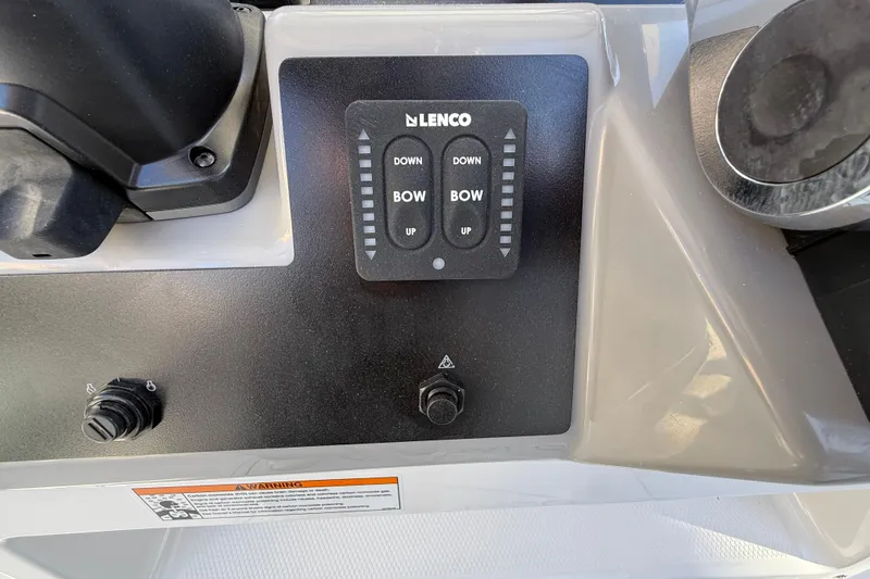 Slide: The Image of 2024 Robalo R230 Center Console boat control panel with Lenco trim tab switches. - 35