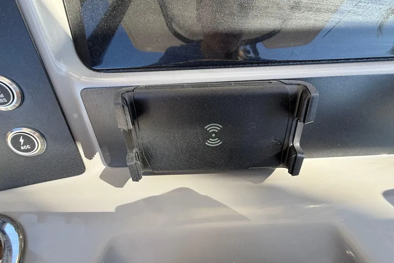 Slide: The Image of 2024 Robalo R230 Center Console dashboard with wireless charging pad. - 36