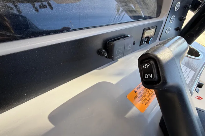 Slide: The Image of 2024 Robalo R230 Center Console dashboard with control lever and buttons. - 37