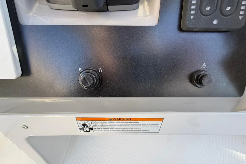 Slide: The Image of 2024 Robalo R230 Center Console dashboard controls with warning label. - 38