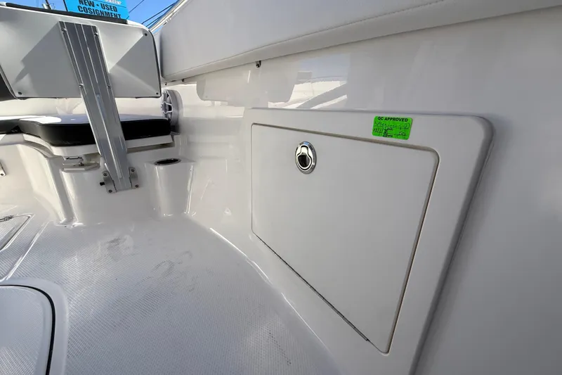 Slide: The Image of 2024 Robalo R230 Center Console interior with storage compartment and seating. - 42