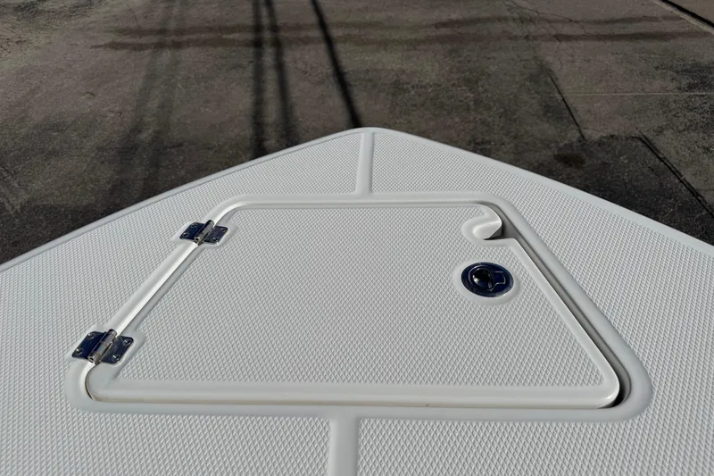 Slide: The Image of 2024 Robalo R230 Center Console boat deck with textured surface and hatch. - 48