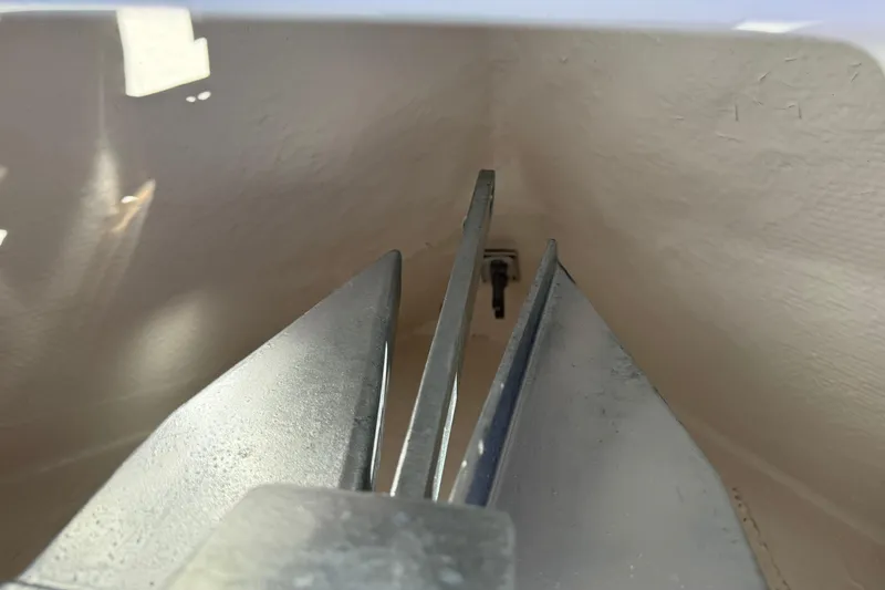 Slide: The Image of Anchor compartment of 2024 Robalo R230 Center Console boat, showcasing metal anchor. - 51