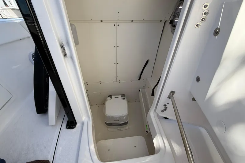 Slide: The Image of 2024 Robalo R230 Center Console interior with compact marine toilet. - 52