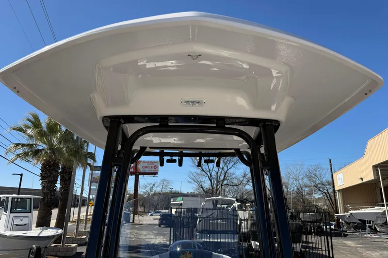 Slide: The Image of 2024 Robalo R230 Center Console boat with T-top, outdoor dealership setting. - 54