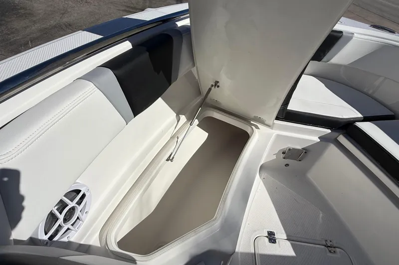 Slide: The Image of 2024 Robalo R230 Center Console boat interior storage compartment with open hatch. - 60