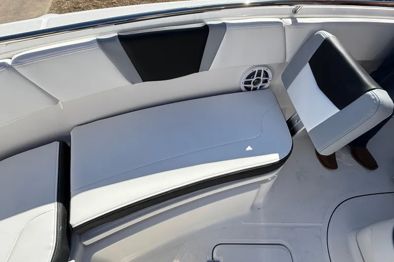 Slide: The Image of 2024 Robalo R230 Center Console boat interior with cushioned seating and speaker. - 63