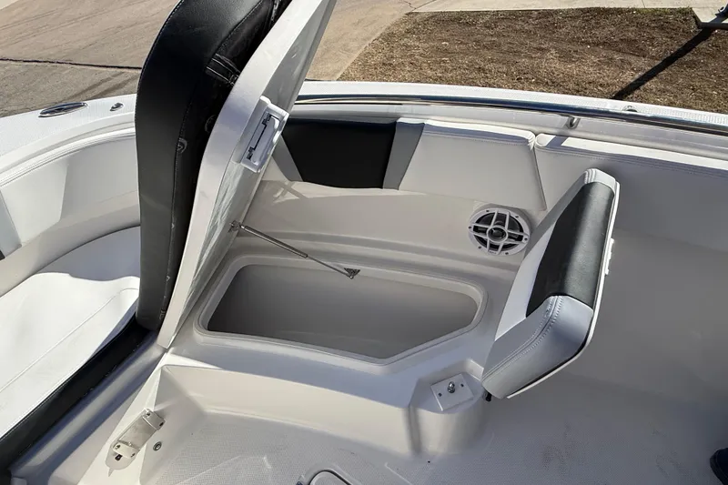 Slide: The Image of 2024 Robalo R230 Center Console boat storage compartment with cushioned seating. - 64
