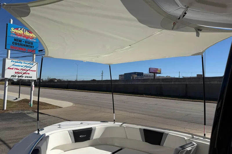 Slide: The Image of 2024 Robalo R230 Center Console boat with sunshade, parked near South Austin Marine sign. - 69