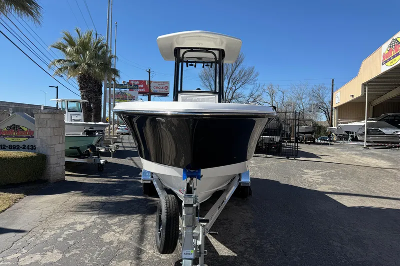 Slide: The Image of 2024 Robalo R230 Center Console boat on trailer in outdoor dealership setting. - 7