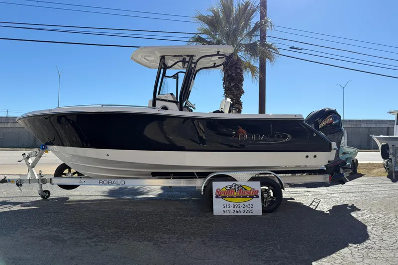 Slide: The Image of 2024 Robalo R230 Center Console boat on trailer, displayed outdoors. - 70
