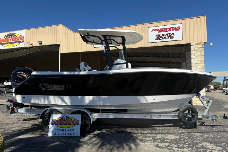 Slide: The Image of 2024 Robalo R230 Center Console boat on trailer at dealership. - 8