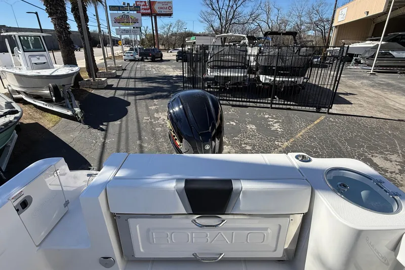 Slide: The Image of 2024 Robalo R230 Center Console boat with Yamaha engine, parked outdoors. - 9