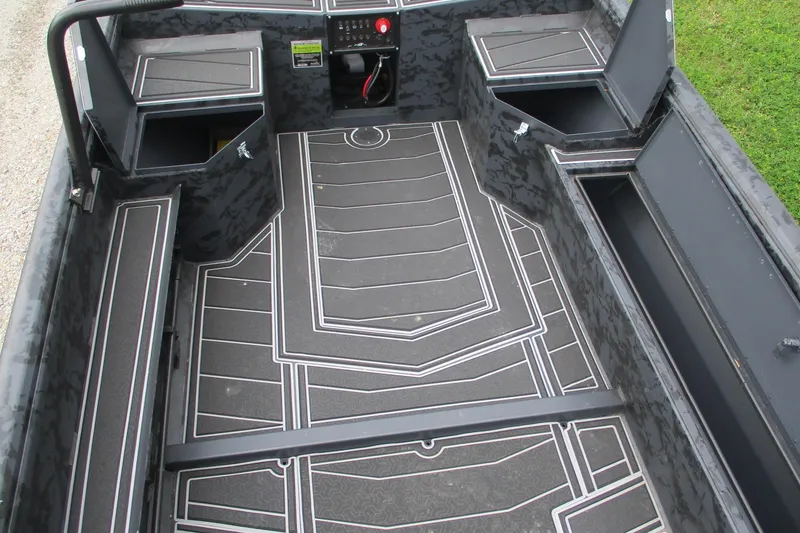 Slide: The Image of 2026 Gator Tail 1750 MID DECK SAVAGE boat interior with storage compartments and patterned flooring. - 10