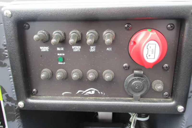 Slide: The Image of Control panel of 2026 Gator Tail 1750 MID DECK SAVAGE boat with switches and battery dial. - 11
