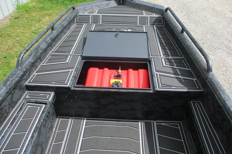 Slide: The Image of 2026 Gator Tail 1750 MID DECK SAVAGE boat interior with storage compartment open. - 5