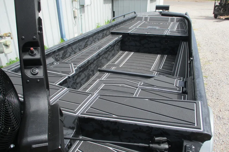 Slide: The Image of 2026 Gator Tail 1750 MID DECK SAVAGE boat interior with sleek black design. - 7