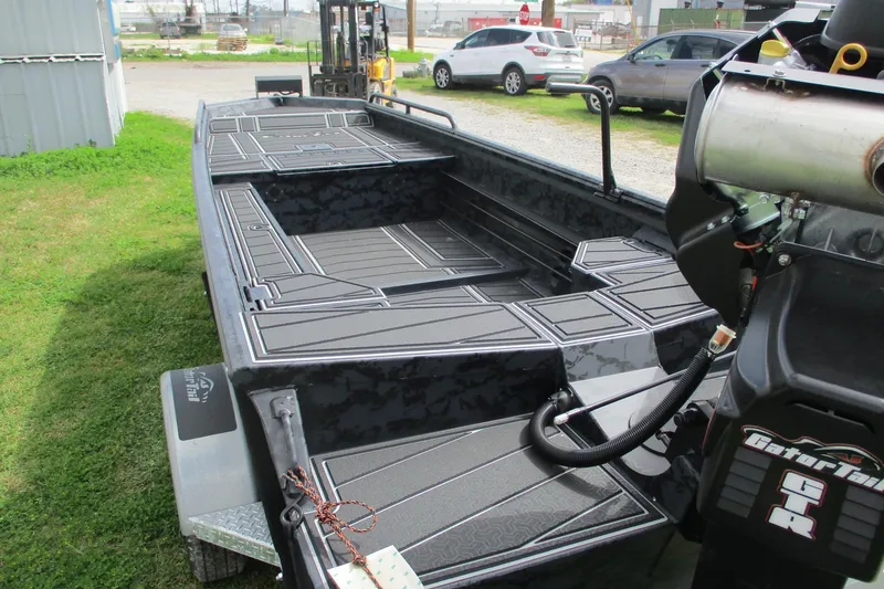 Slide: The Image of 2026 Gator Tail 1750 MID DECK SAVAGE boat with sleek design on grass. - 8