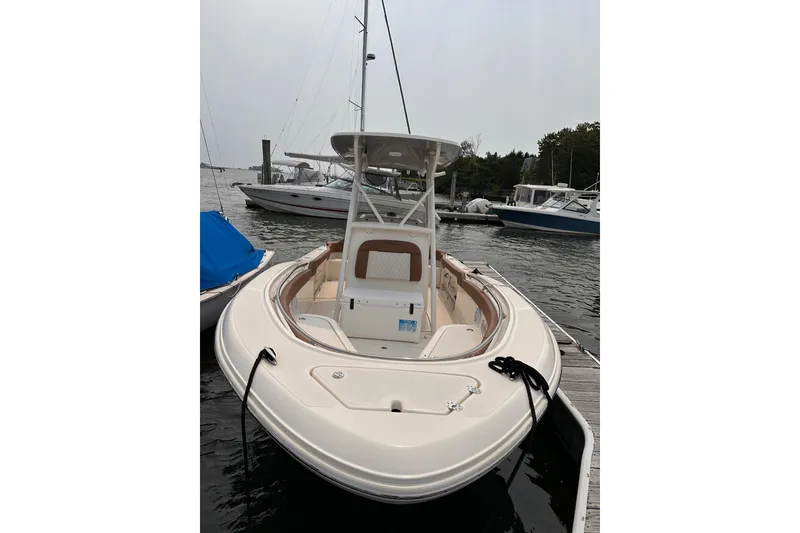 The Image of 2024 Pioneer 222 Islander boat docked, showcasing sleek design and spacious deck. - 0