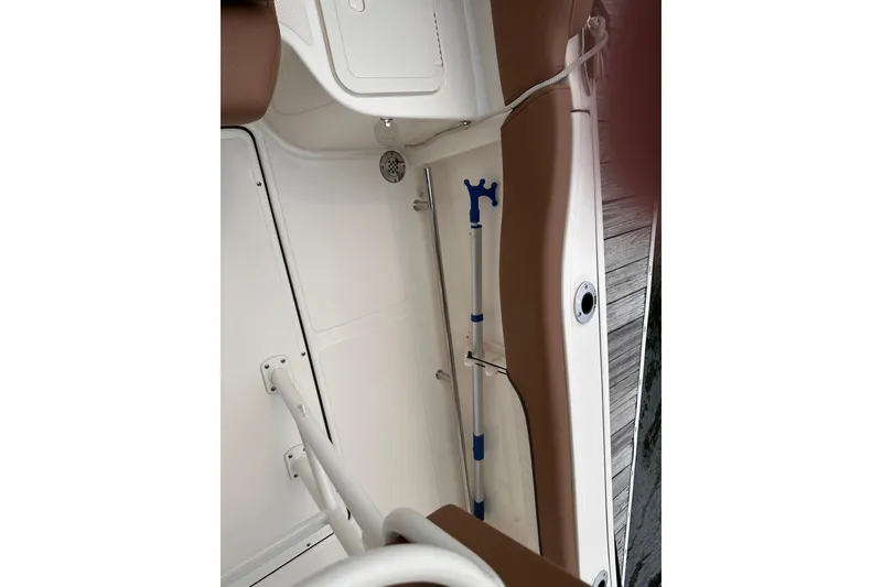 Slide: The Image of 2024 Pioneer 222 Islander boat interior with storage compartment and equipment. - 15