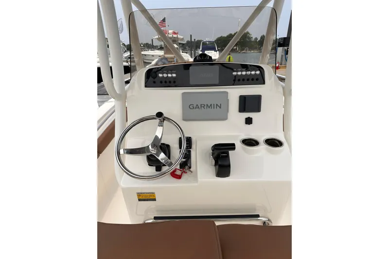 Slide: The Image of 2024 Pioneer 222 Islander boat console with Garmin navigation system and steering wheel. - 5