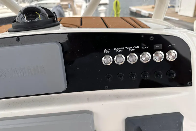 Slide: The Image of Control panel of 2024 Pioneer 222 Islander boat with Yamaha components and various pump switches. - 8
