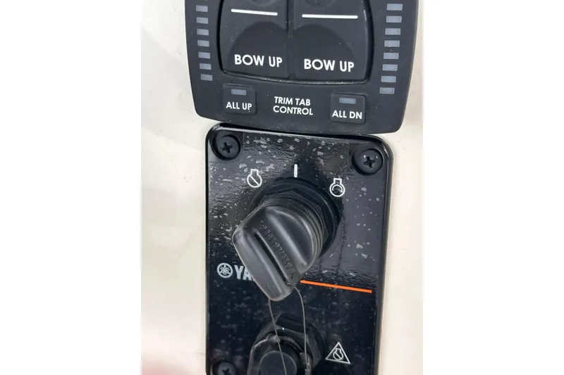 Slide: The Image of 2024 Pioneer 222 Islander boat controls with Yamaha ignition and trim tab panel. - 9