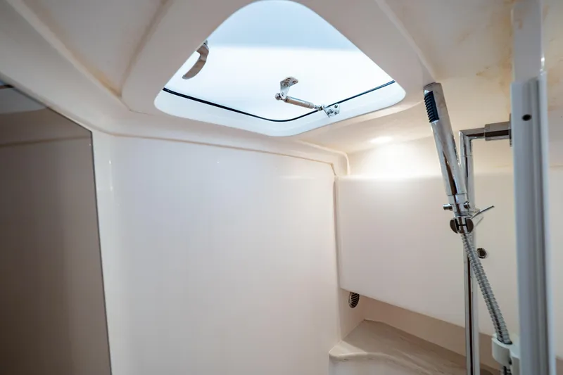 Slide: The Image of 2019 Intrepid 407 Cuddy interior shower with skylight and modern fixtures. - 102