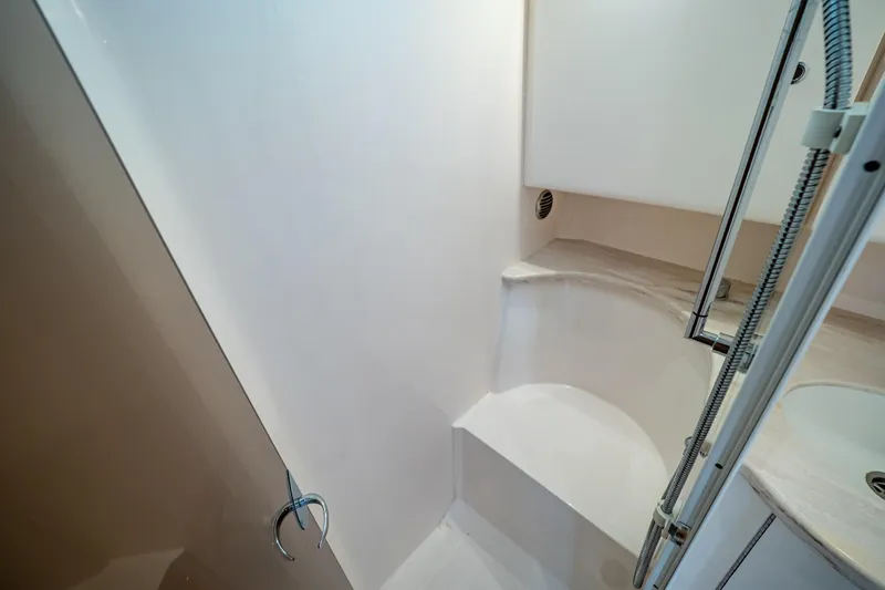 Slide: The Image of 2019 Intrepid 407 Cuddy interior shower area with modern design and fixtures. - 103