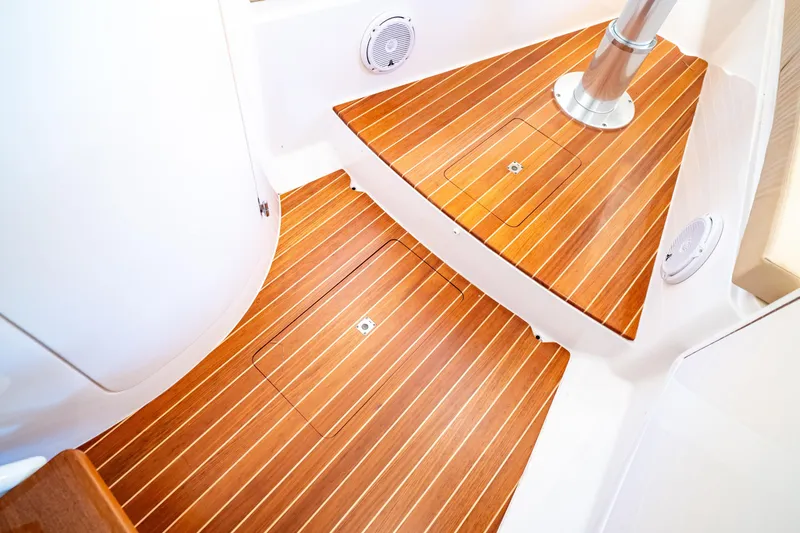 Slide: The Image of 2019 Intrepid 407 Cuddy interior with sleek wooden flooring and modern design elements. - 107