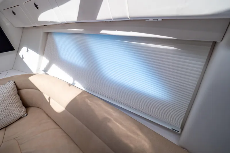 Slide: The Image of Interior of 2019 Intrepid 407 Cuddy with beige seating and window shade. - 108