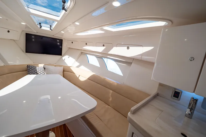 Slide: The Image of Luxurious interior of 2019 Intrepid 407 Cuddy boat with skylights and seating area. - 109