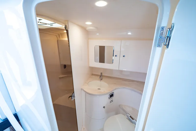 Slide: The Image of Luxurious bathroom interior of 2019 Intrepid 407 Cuddy boat, featuring modern fixtures and lighting. - 11