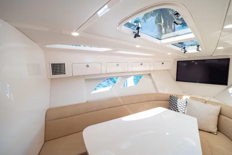 Slide: The Image of Luxurious interior of 2019 Intrepid 407 Cuddy with skylights, seating, and TV. - 110