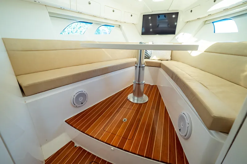 Slide: The Image of Luxurious 2019 Intrepid 407 Cuddy interior with plush seating and elegant wood flooring. - 111