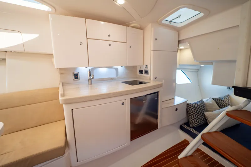 Slide: The Image of Luxurious interior of 2019 Intrepid 407 Cuddy boat with modern kitchenette and seating area. - 112