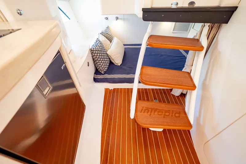 Slide: The Image of Interior of 2019 Intrepid 407 Cuddy with wooden steps and cozy bedding. - 114