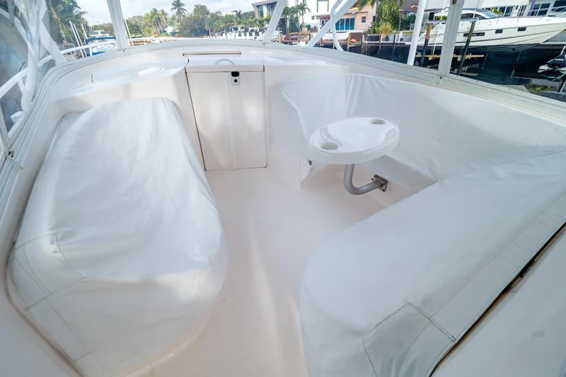 Slide: The Image of 2019 Intrepid 407 Cuddy interior with white seating and small table. - 128
