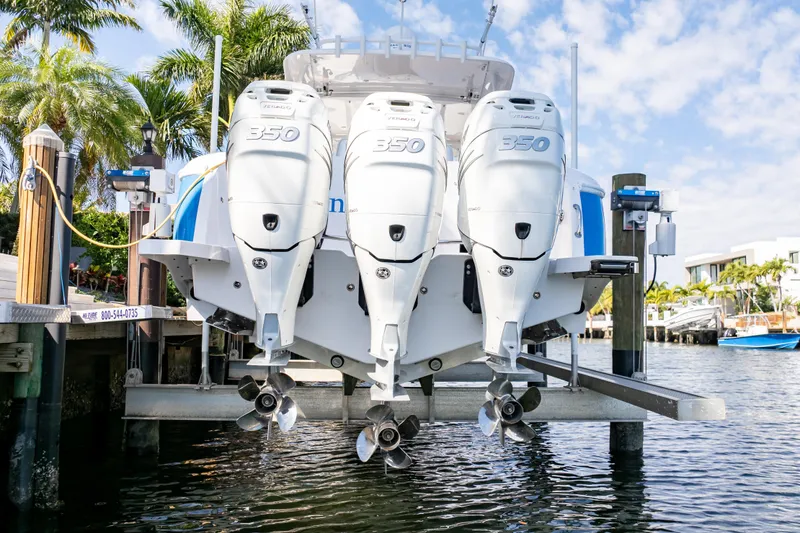 Slide: The Image of 2019 Intrepid 407 Cuddy with triple 350 engines docked by palm trees. - 18