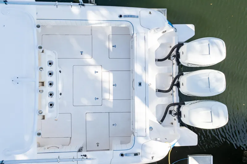 Slide: The Image of Overhead view of 2019 Intrepid 407 Cuddy boat with triple outboard engines. - 22