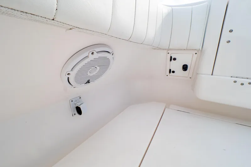 Slide: The Image of Interior of 2019 Intrepid 407 Cuddy boat featuring speaker and seating area. - 34