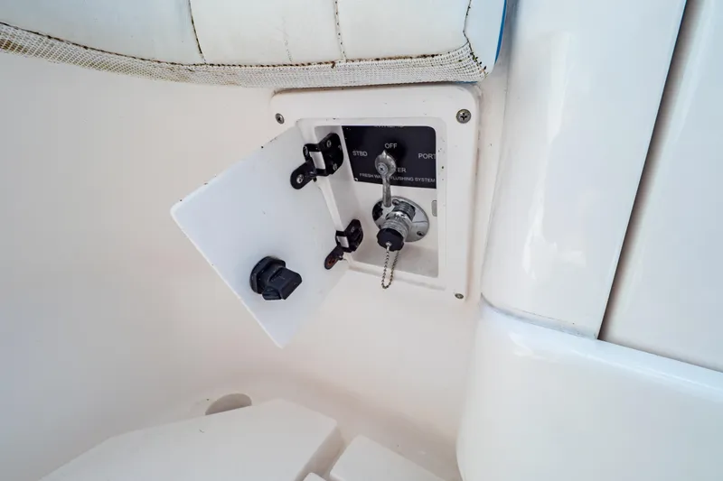Slide: The Image of Control panel on a 2019 Intrepid 407 Cuddy boat, featuring switches and key access. - 35