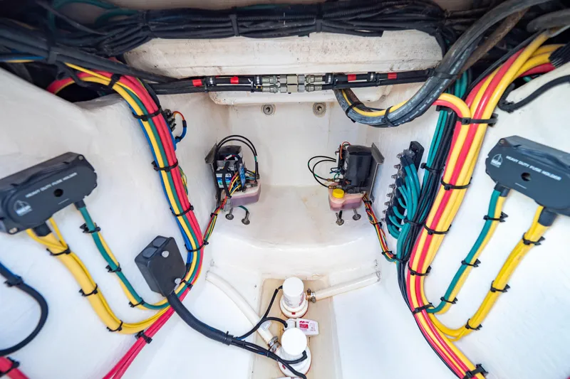 Slide: The Image of Electrical wiring system inside a 2019 Intrepid 407 Cuddy boat, showcasing organized cables and components. - 37