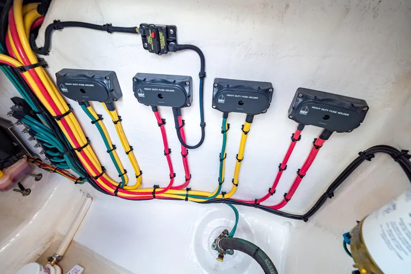 Slide: The Image of Color-coded wiring and fuse holders in a 2019 Intrepid 407 Cuddy boat. - 38