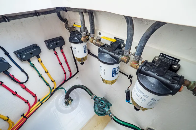 Slide: The Image of Engine compartment of 2019 Intrepid 407 Cuddy with fuel filters and color-coded wiring. - 39