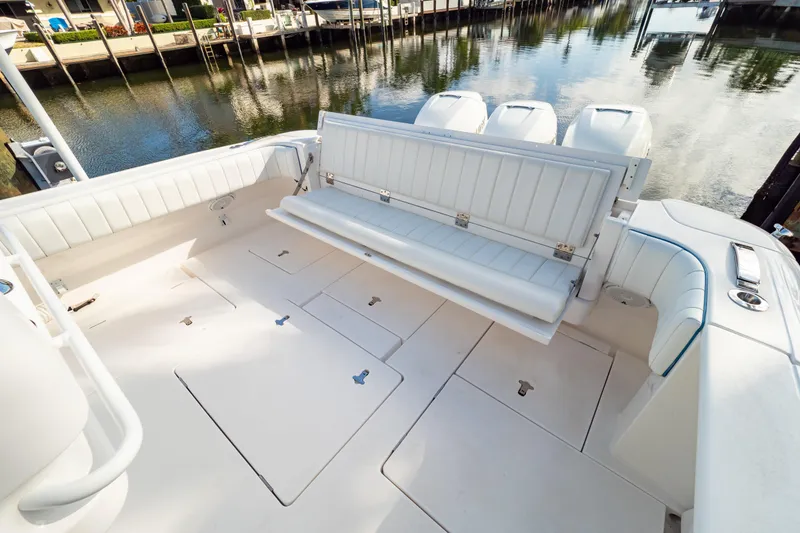 Slide: The Image of 2019 Intrepid 407 Cuddy boat interior with foldable seating and spacious deck. - 4