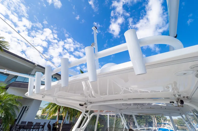 Slide: The Image of 2019 Intrepid 407 Cuddy boat with rod holders, under clear blue sky. - 46