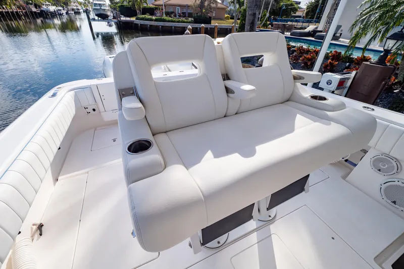 Slide: The Image of 2019 Intrepid 407 Cuddy boat interior with plush seating and cup holders. - 48